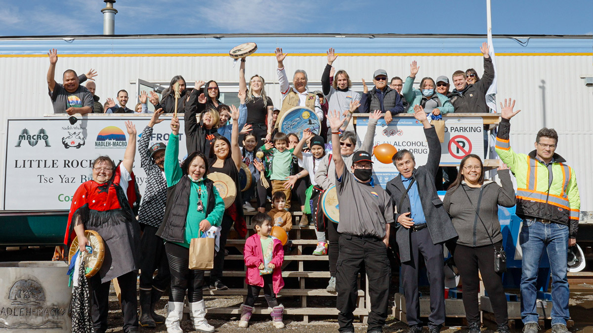 People waving and smiling at ceremony