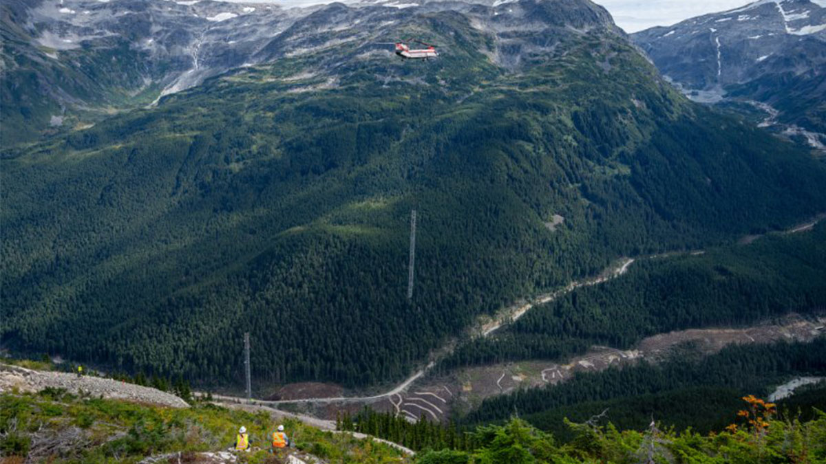 A mountain with workers in the foreground